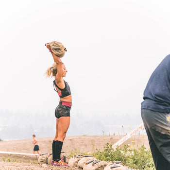 Overhead press on the Spartan WRECKED obstacle using the Elite Force Gear Wrecker Training Sandbag